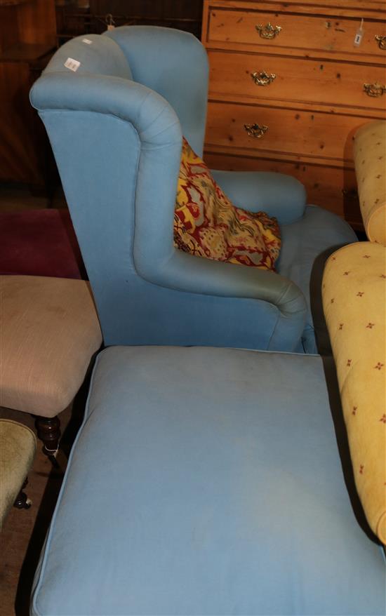 Blue fabric upholstered wing-back armchair and stool(-)